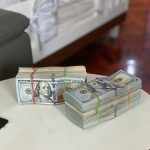 a stack of money sitting on top of a white table