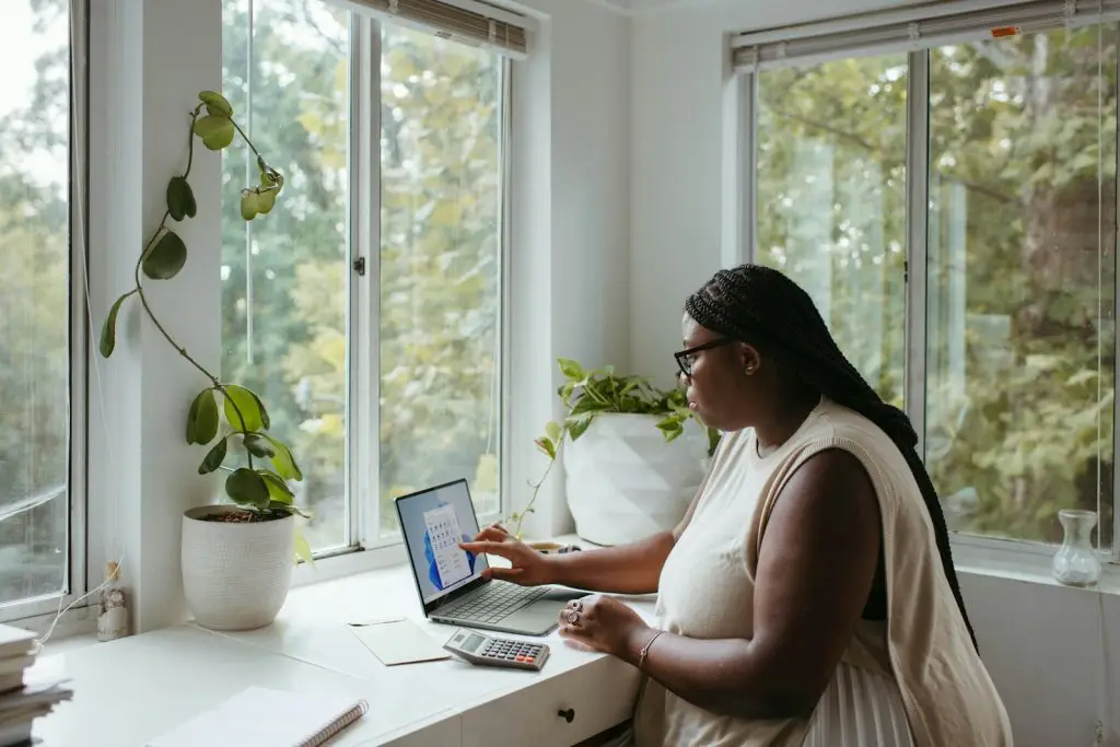 10 Best Ways to Make Money Online in Nigeria 3 a woman sitting at a table with a laptop